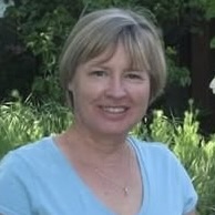 women in blue shirt smiling