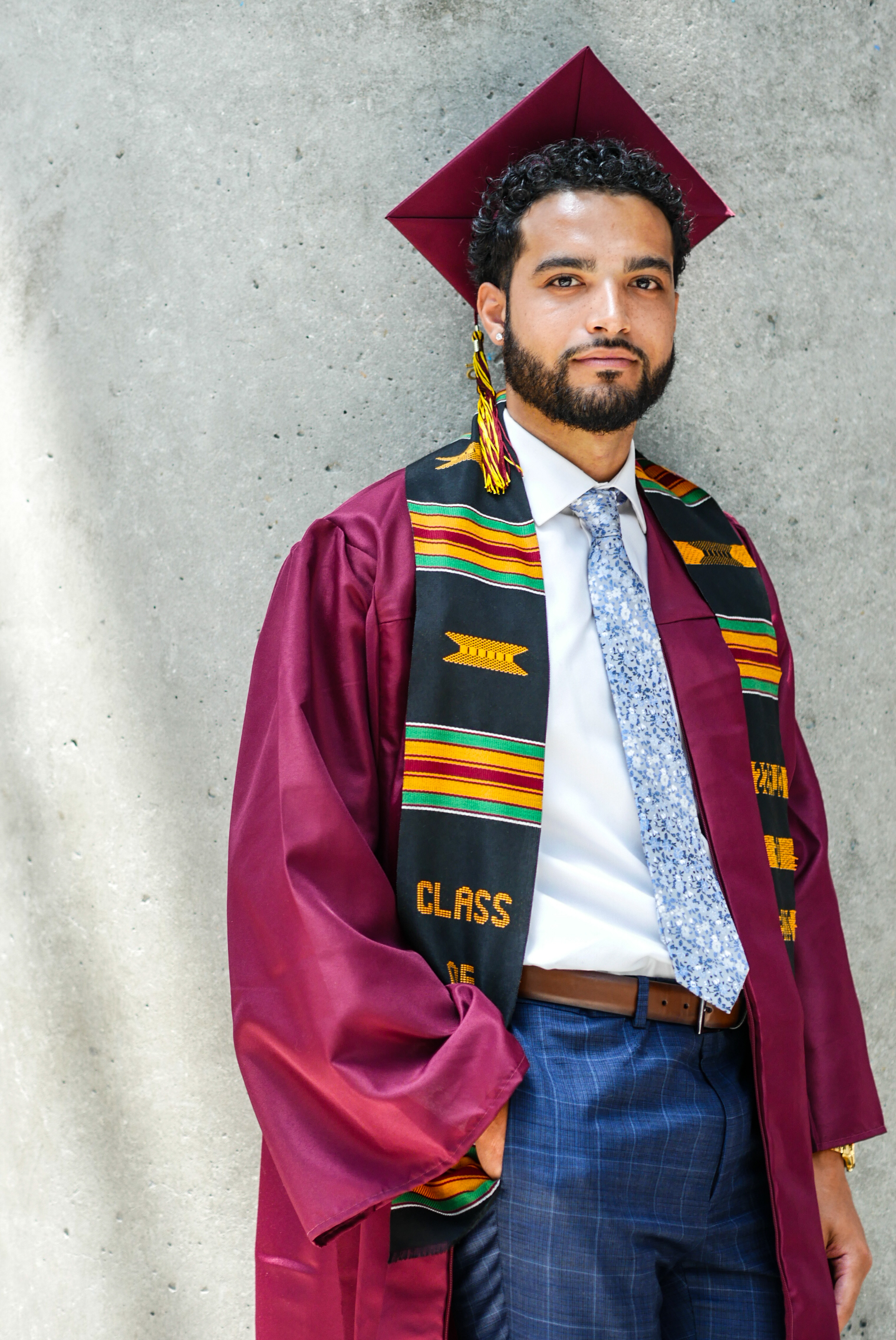 Grad leaning against the wall