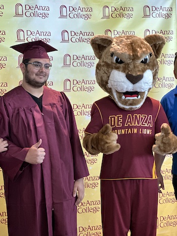 Roary giving thumbs up with grad